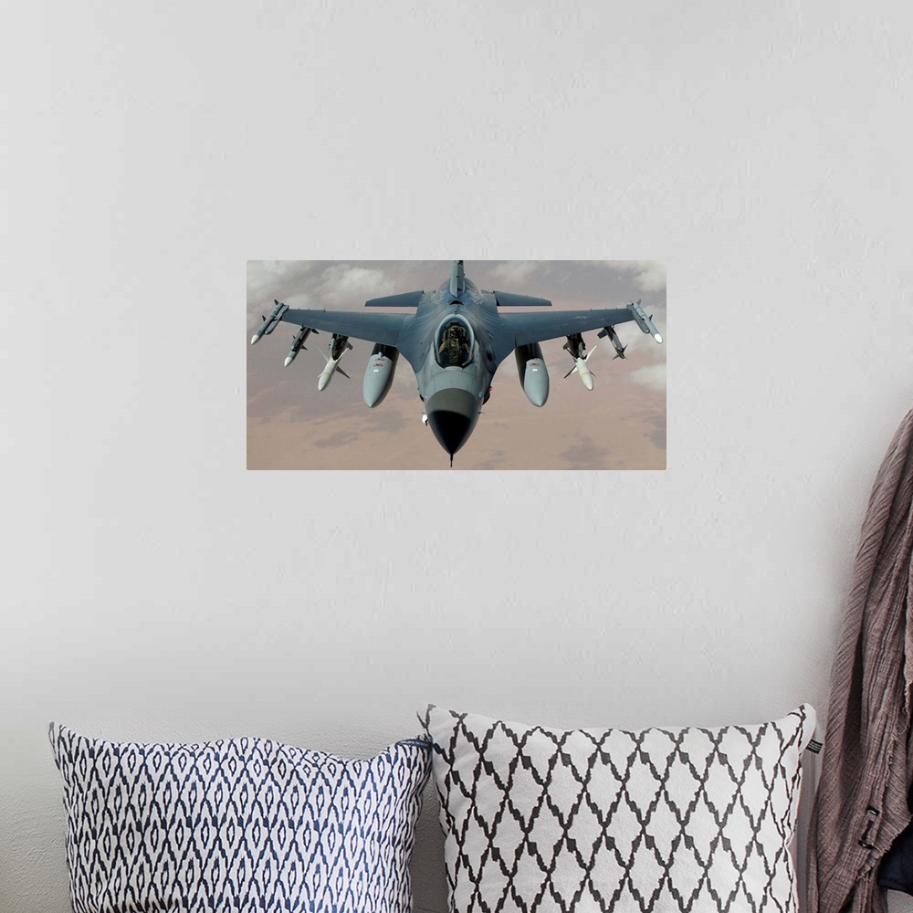 A bohemian room featuring An F-16 Fighting Falcon flies a mission in the skies near Iraq.
