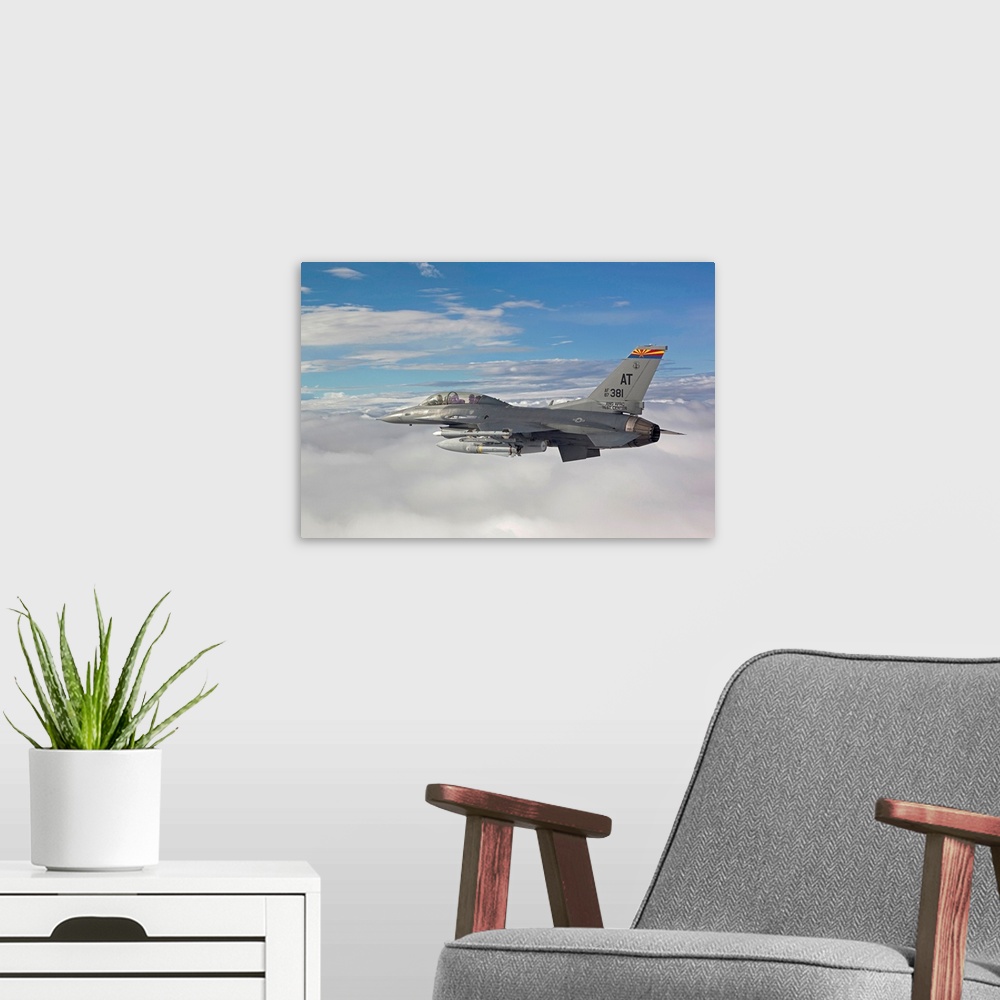 A modern room featuring An F-16 Fighting Falcon from the Air National Guard Air Force Reserve Test Center flies with an A...