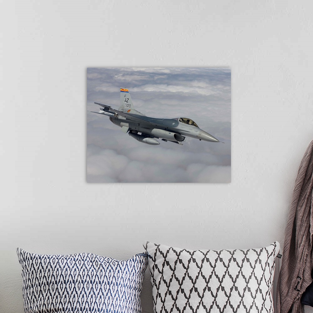A bohemian room featuring An F-16 Fighting Falcon from the 162nd Fighter Wing maneuvers during a training mission out of Tu...