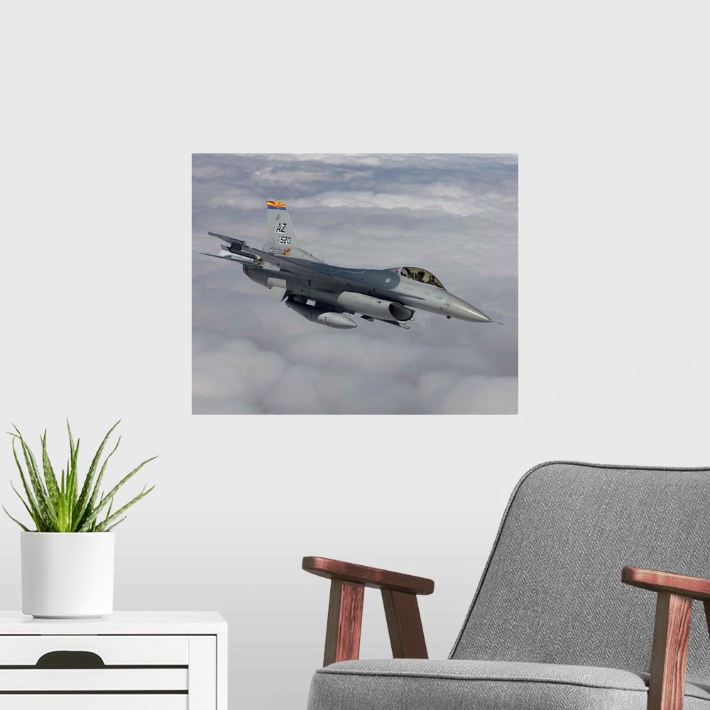 A modern room featuring An F-16 Fighting Falcon from the 162nd Fighter Wing maneuvers during a training mission out of Tu...