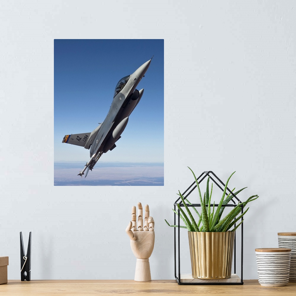 A bohemian room featuring An F-16 Fighting Falcon from the 162nd Fighter Wing maneuvers during a training mission out of Da...