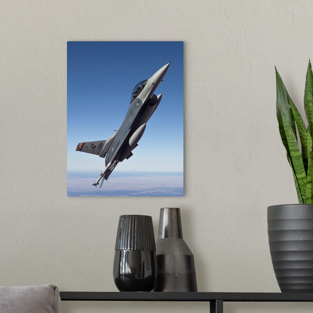 A modern room featuring An F-16 Fighting Falcon from the 162nd Fighter Wing maneuvers during a training mission out of Da...