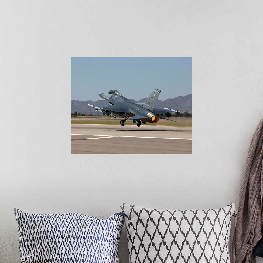 A bohemian room featuring A 56th Fighter Wing F-16 Fighting Falcon from Luke Air Force Base, Arizona, takes off on a traini...