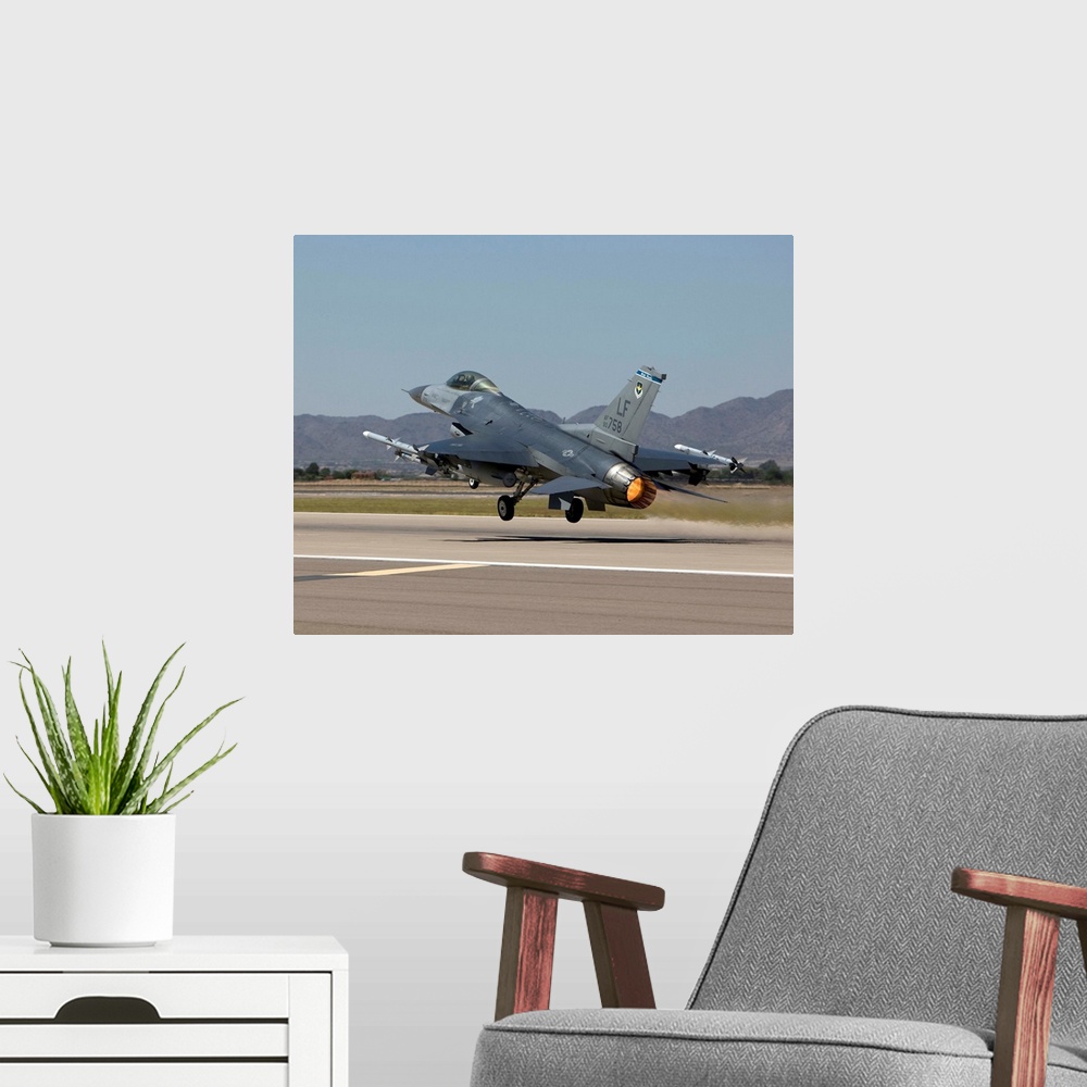 A modern room featuring A 56th Fighter Wing F-16 Fighting Falcon from Luke Air Force Base, Arizona, takes off on a traini...