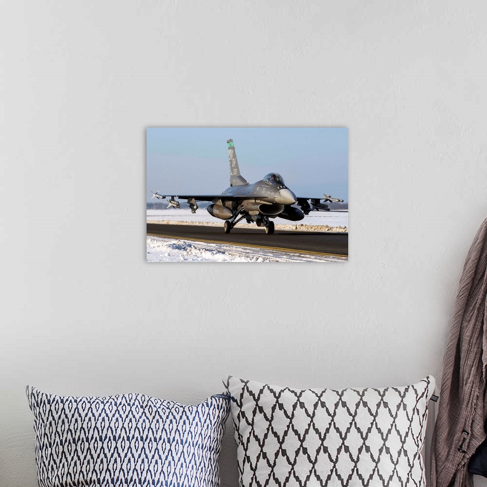 A bohemian room featuring An F-16 from the 180th Fighter Wing, taxiing on the runway at Amari Air Base, Estonia.
