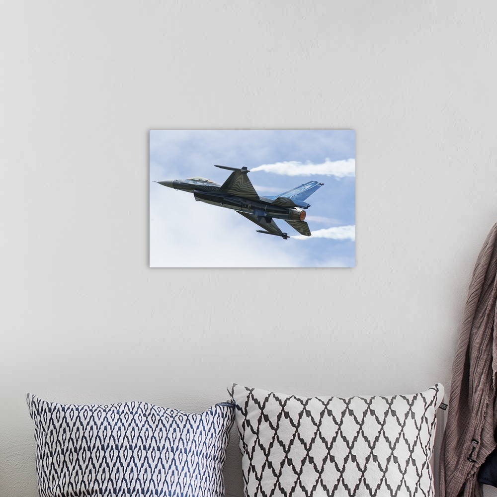 A bohemian room featuring An F-16A Mide-Life Update of the Belgian Air Force in flight.