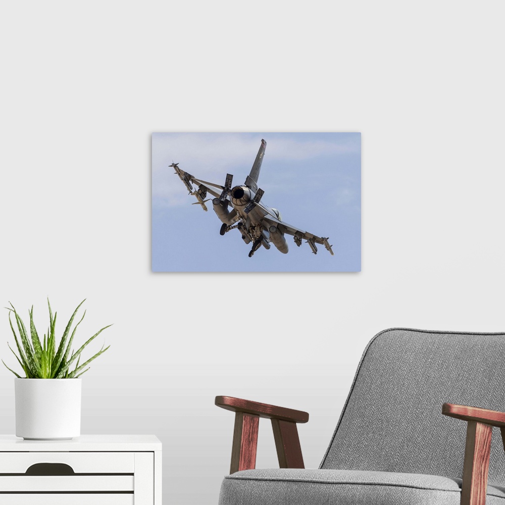 A modern room featuring An F-16C Fighting Falcon of the U.S. Air Force turns on to final approach at Nellis Air Force Bas...