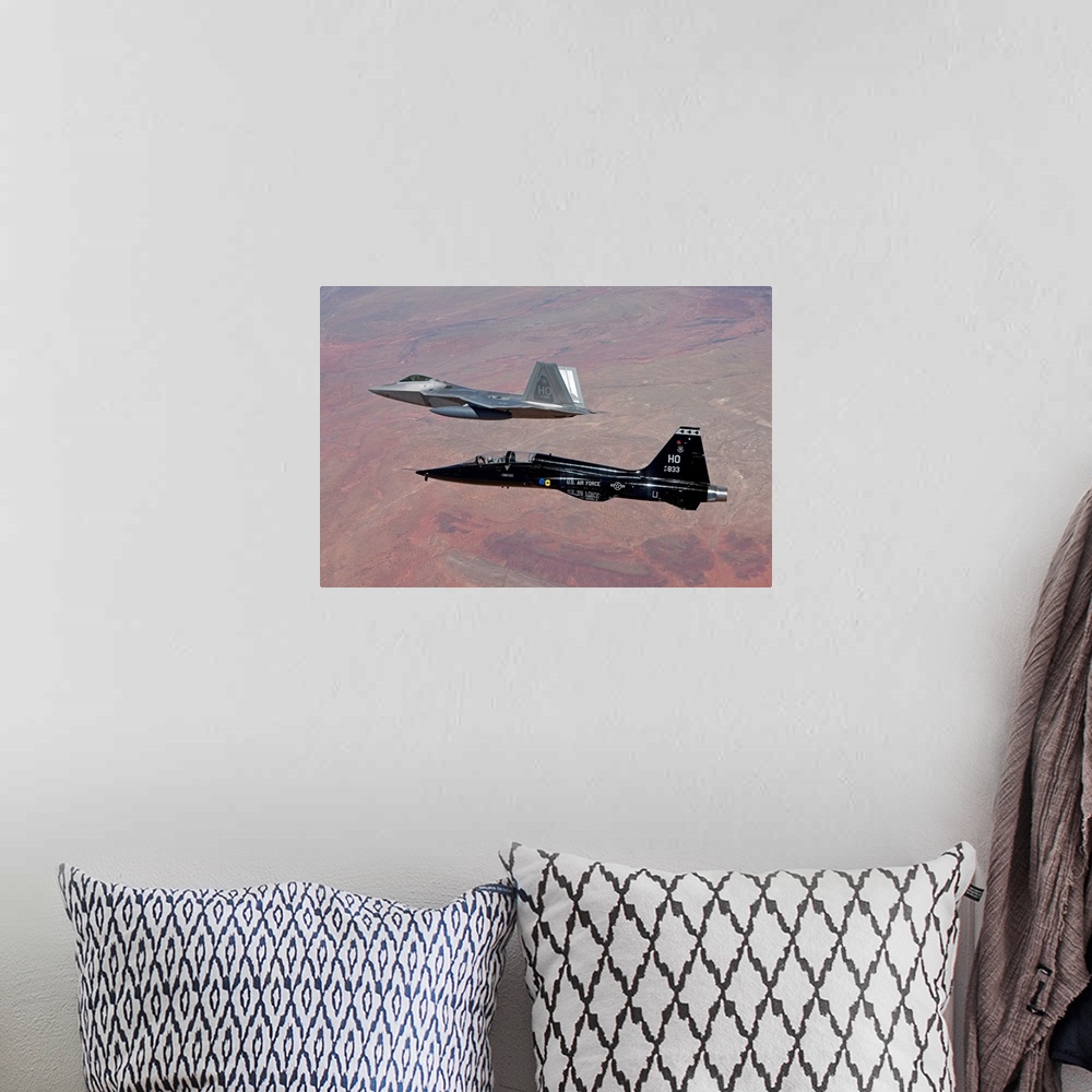 A bohemian room featuring An F-22 Raptor from the 49th Fighter Wing flies in formation with a T-38 Talon while on a trainin...