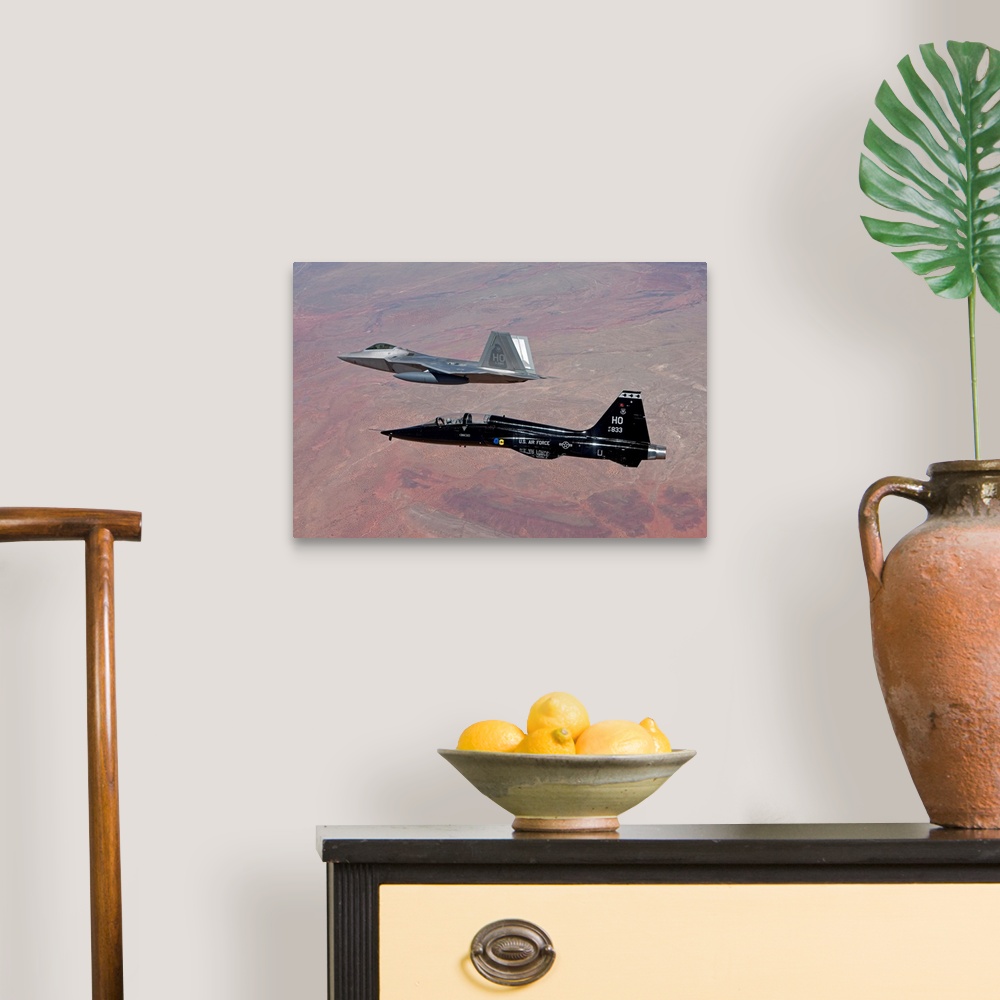 A traditional room featuring An F-22 Raptor from the 49th Fighter Wing flies in formation with a T-38 Talon while on a trainin...