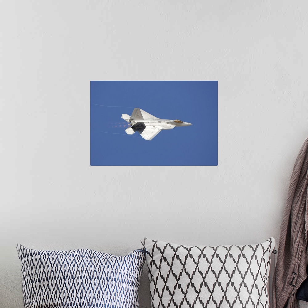 A bohemian room featuring An F-22 Raptor in flight over Nellis Air Force Base, Nevada.