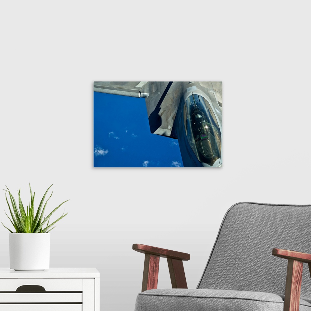 A modern room featuring An F-22 Raptor in flight over the Hawaiian Islands.