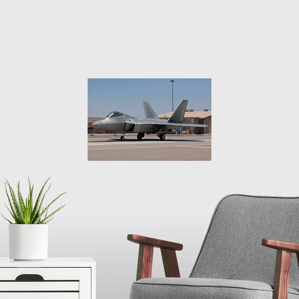 A modern room featuring An F-22 Raptor taxi's to the runway for a training mission out of Holloman Air Force Base, New Me...