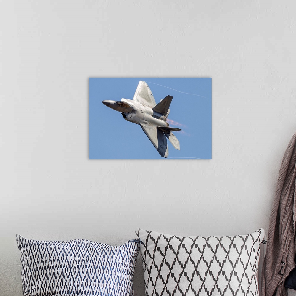 A bohemian room featuring An F-22A Raptor of the U.S. Air Force turns at high speed.