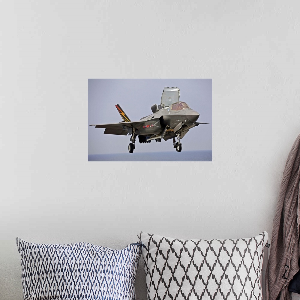 A bohemian room featuring August 27, 2013 - An F-35 Lightning II short take-off/vertical landing aircraft hovers prior to l...