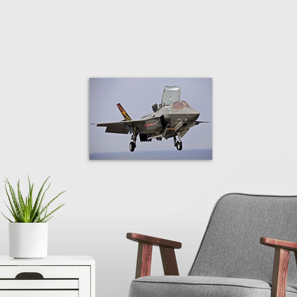 A modern room featuring August 27, 2013 - An F-35 Lightning II short take-off/vertical landing aircraft hovers prior to l...