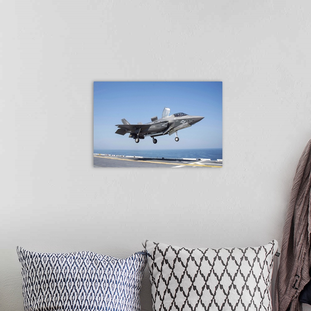 A bohemian room featuring An F-35B Lighting II lands on the flight deck of USS Wasp.