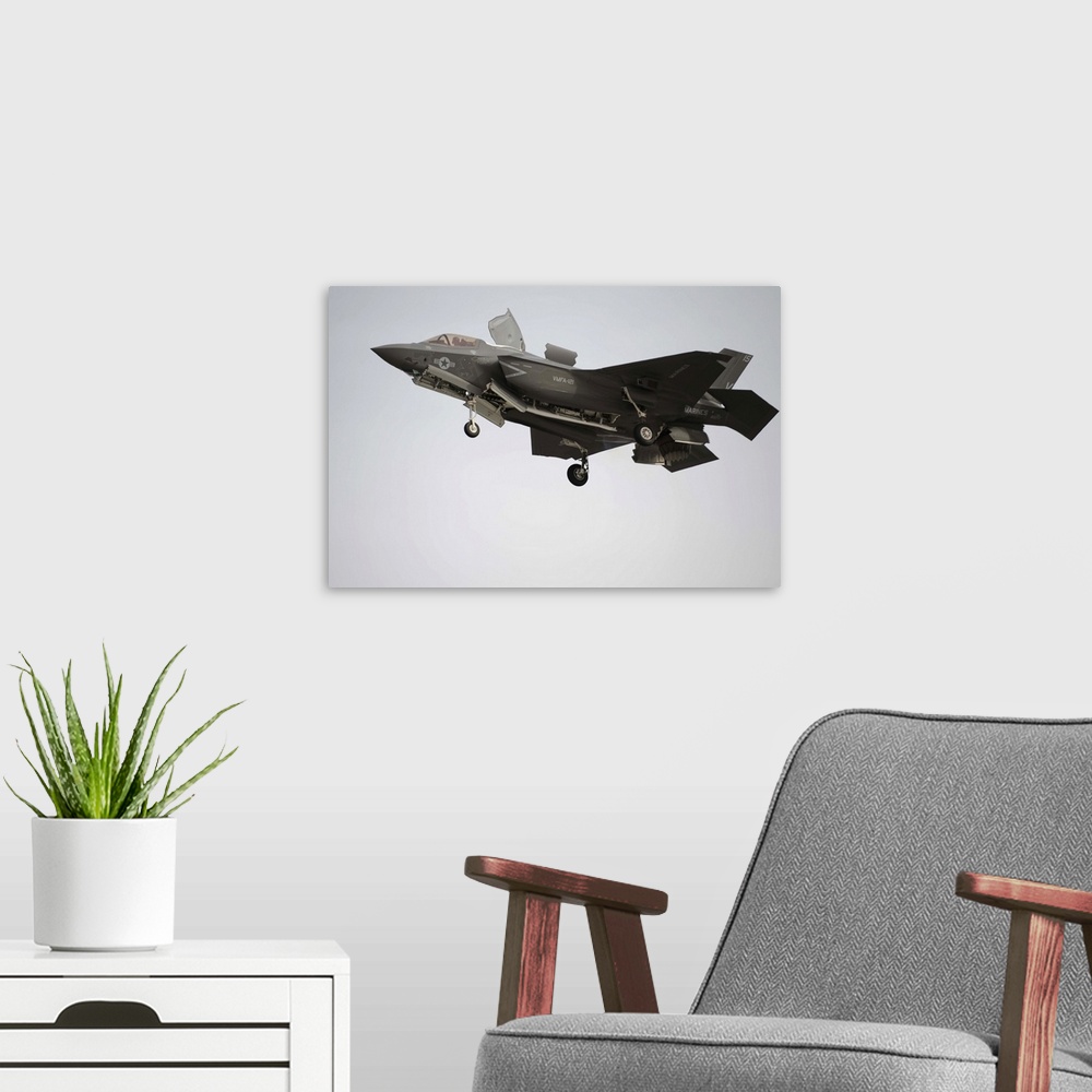 A modern room featuring March 21, 2013 - An F-35B Lightning II Joint Strike Fighter prepares to make a vertical landing a...