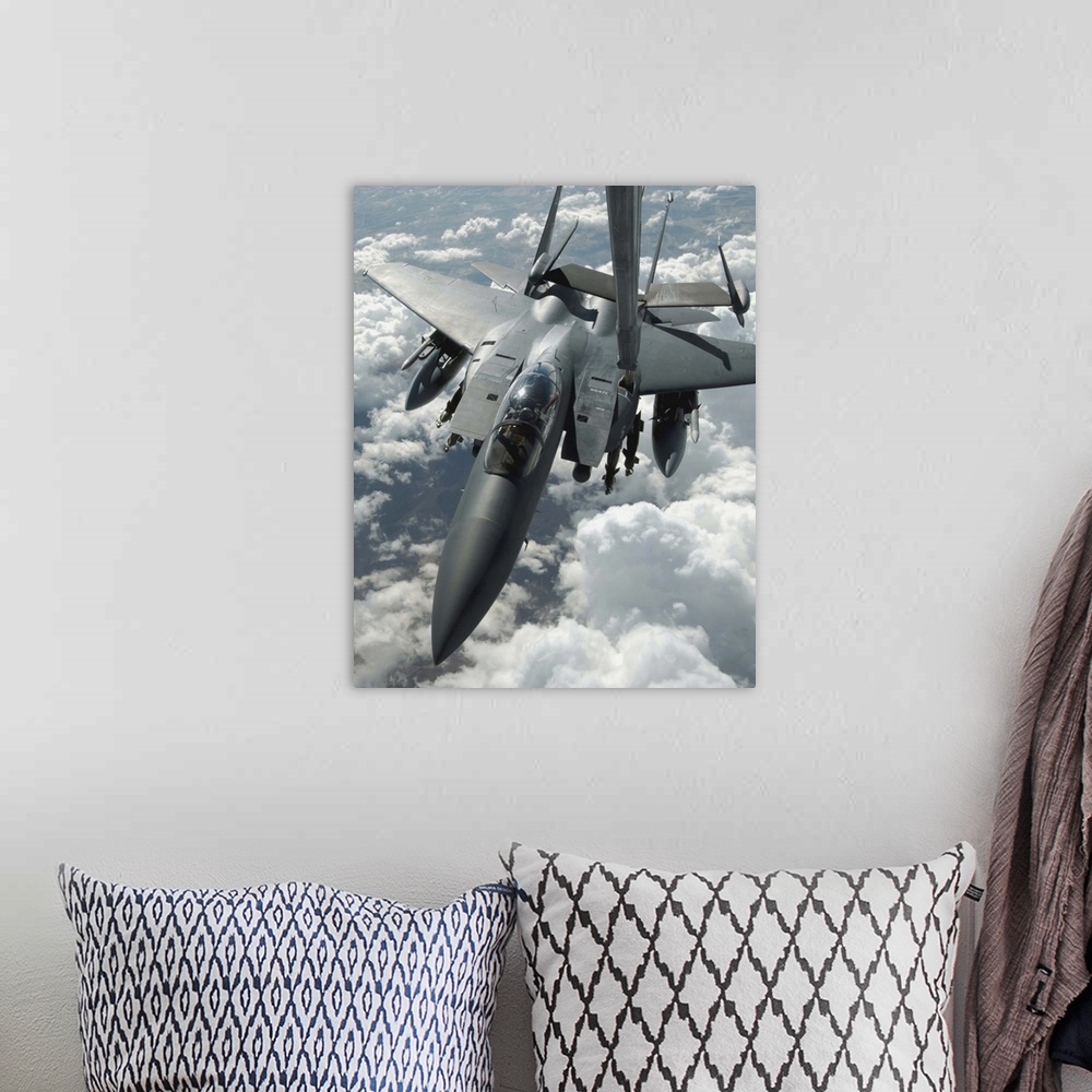 A bohemian room featuring An F15 E Strike Eagle receives fuel from a KC10 Extender