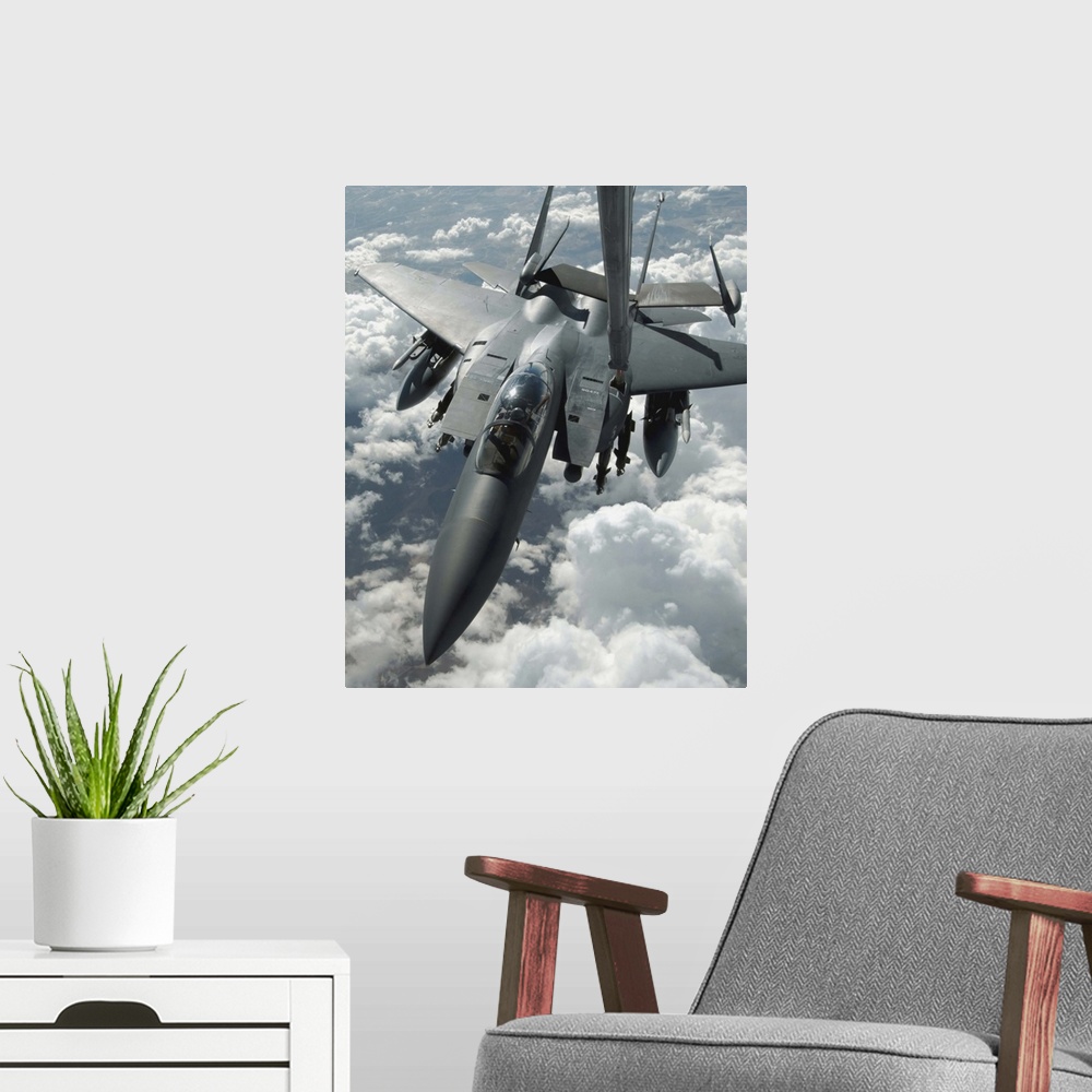 A modern room featuring An F15 E Strike Eagle receives fuel from a KC10 Extender