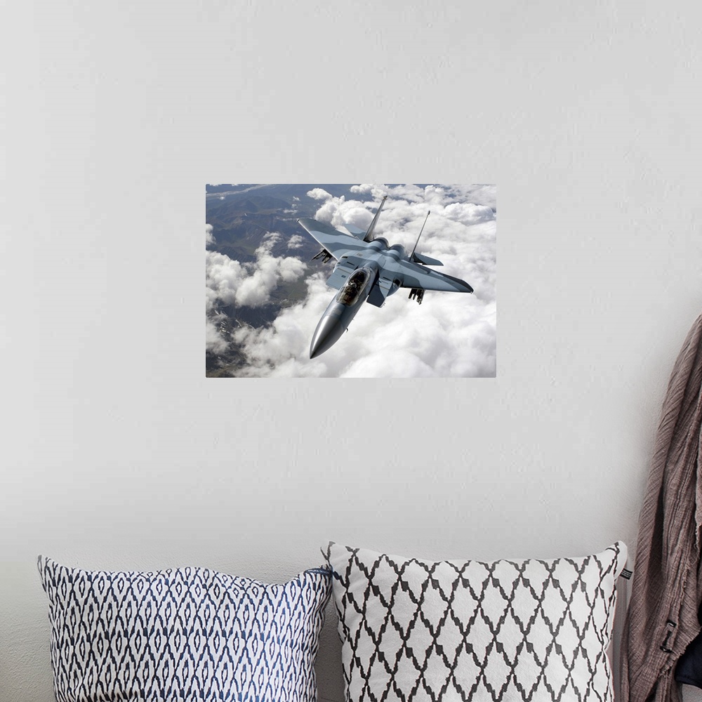 A bohemian room featuring An F15C Aggressor flies over a mountain range