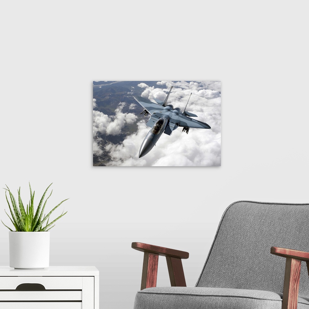 A modern room featuring An F15C Aggressor flies over a mountain range