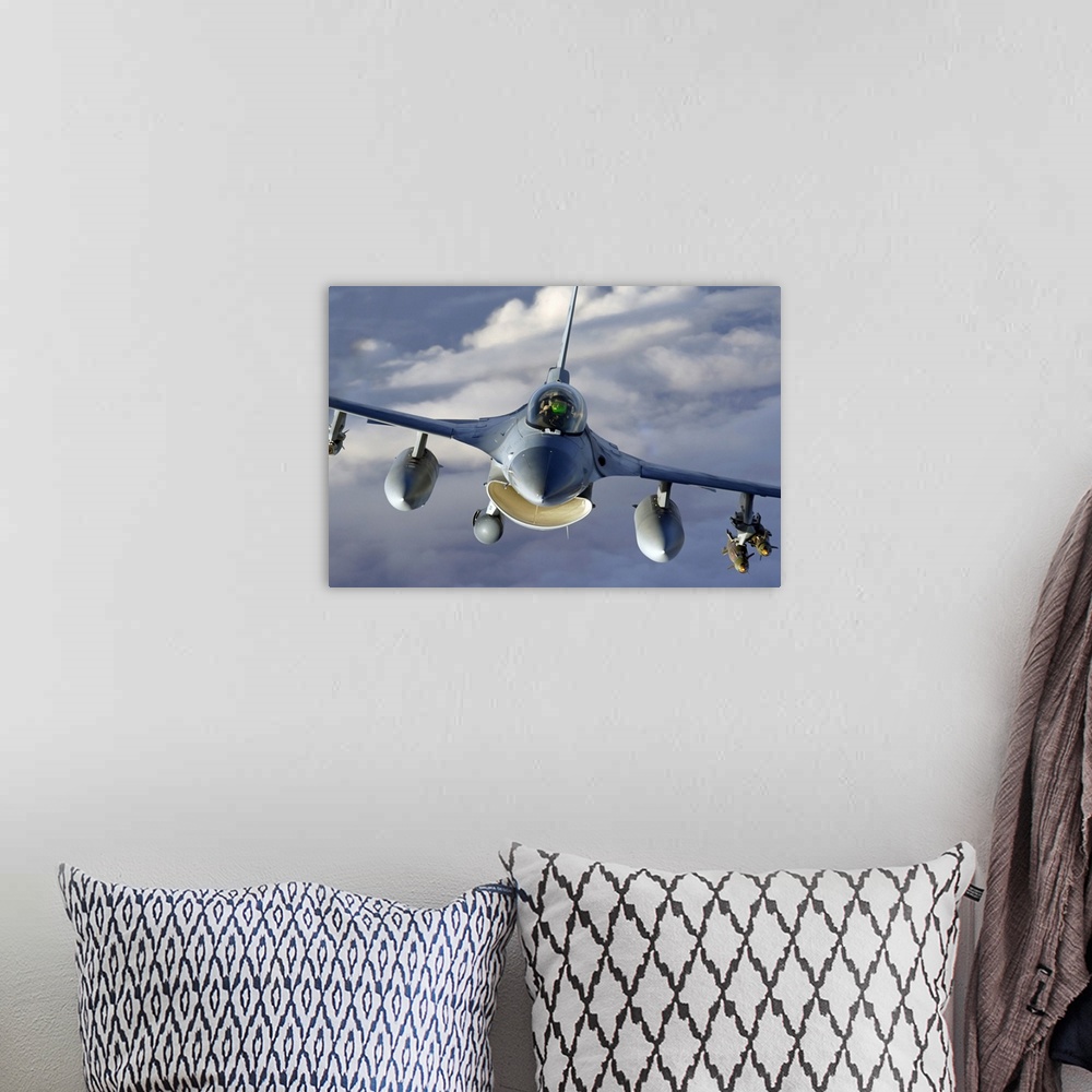 A bohemian room featuring Canvas photo art of the up close of a jet flying through the skies.