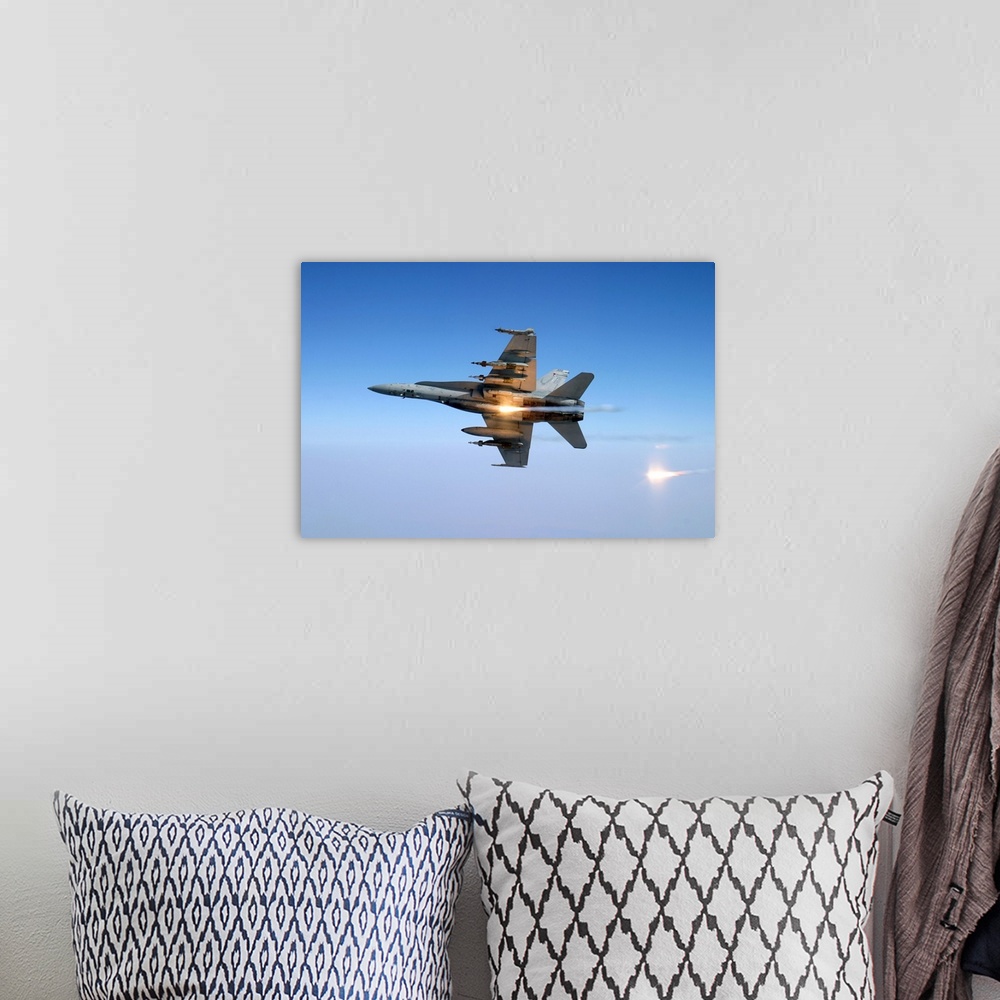 A bohemian room featuring An F/A-18C Hornet aircraft tests its flare countermeasure system.