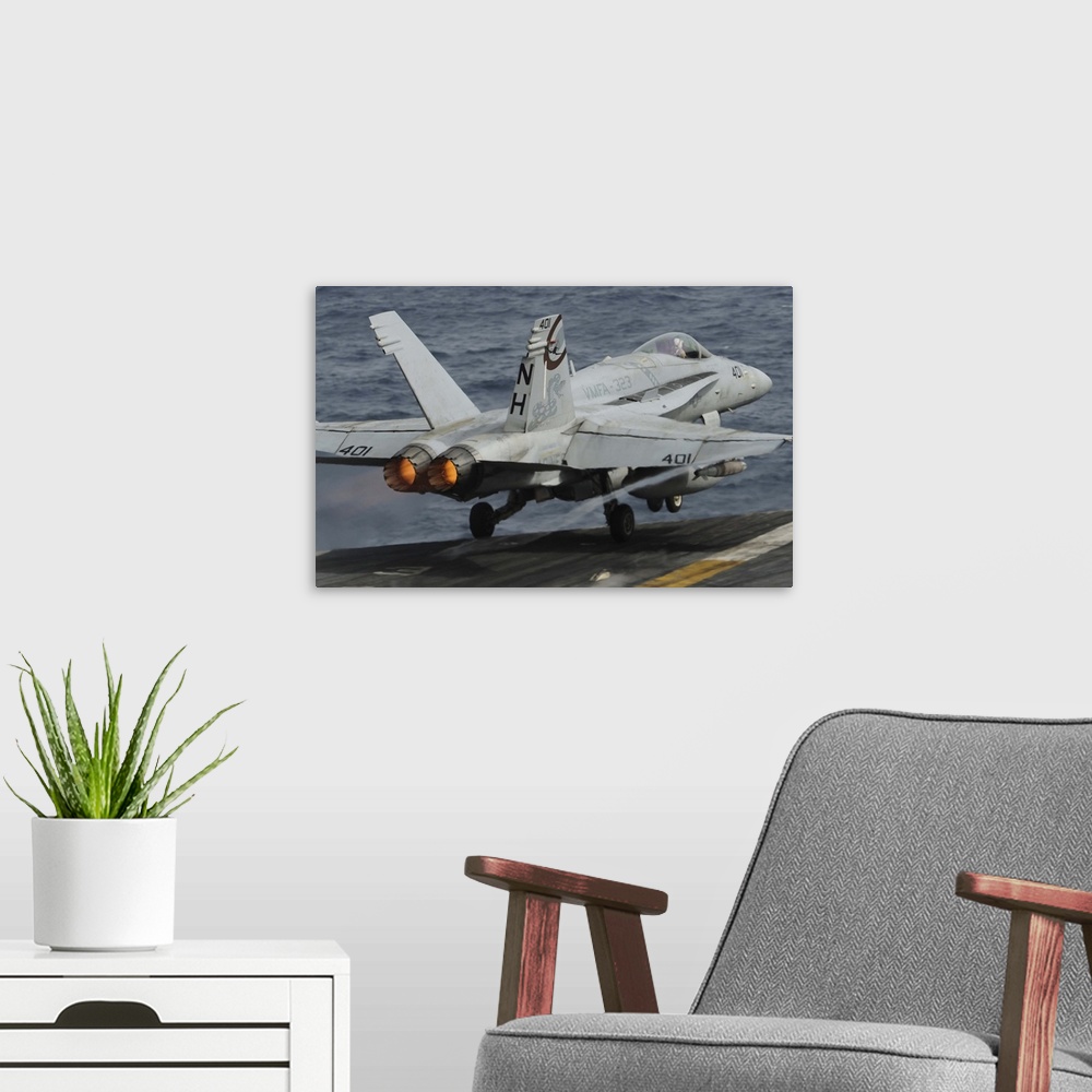 A modern room featuring Gulf of Oman, July 1, 2013 - An F/A-18C Hornet launches off the flight deck of the aircraft carri...
