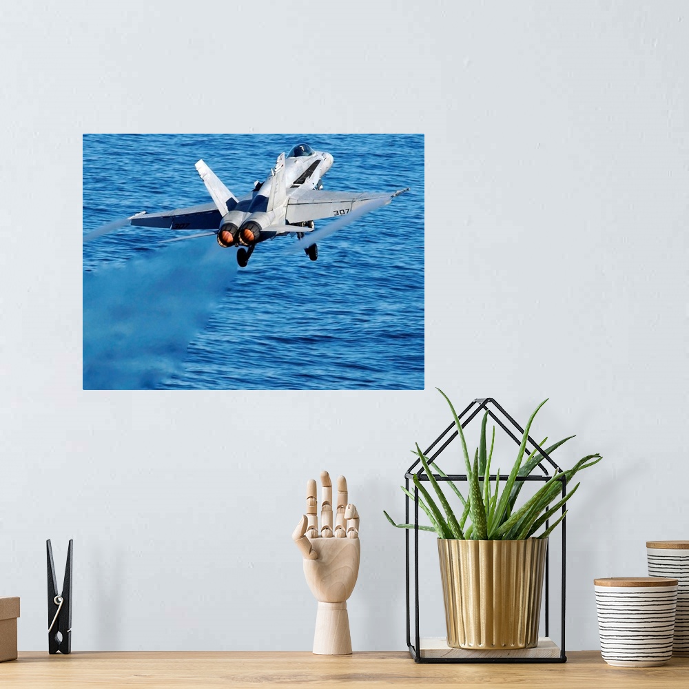 A bohemian room featuring An F/A-18C Hornet taking off.