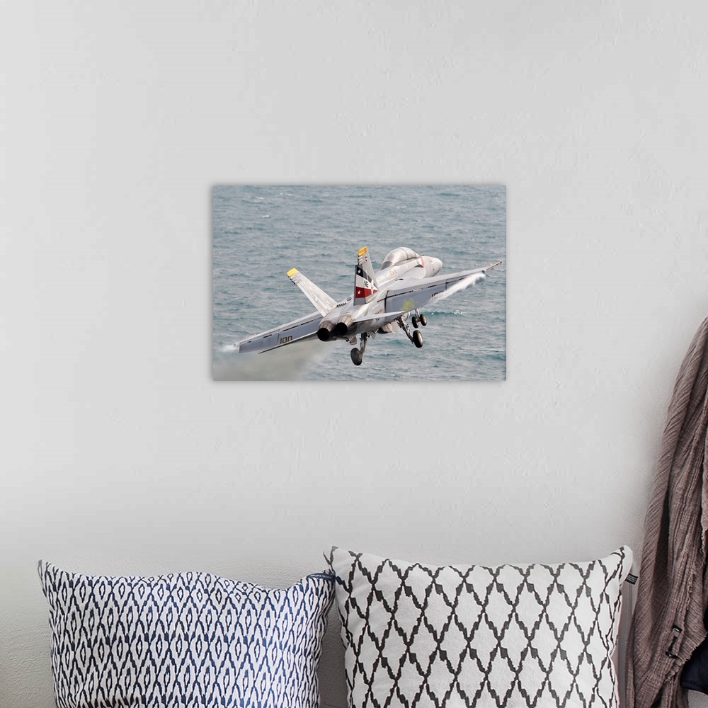 A bohemian room featuring An F/A-18F Super Hornet launches from USS Abraham Lincoln.