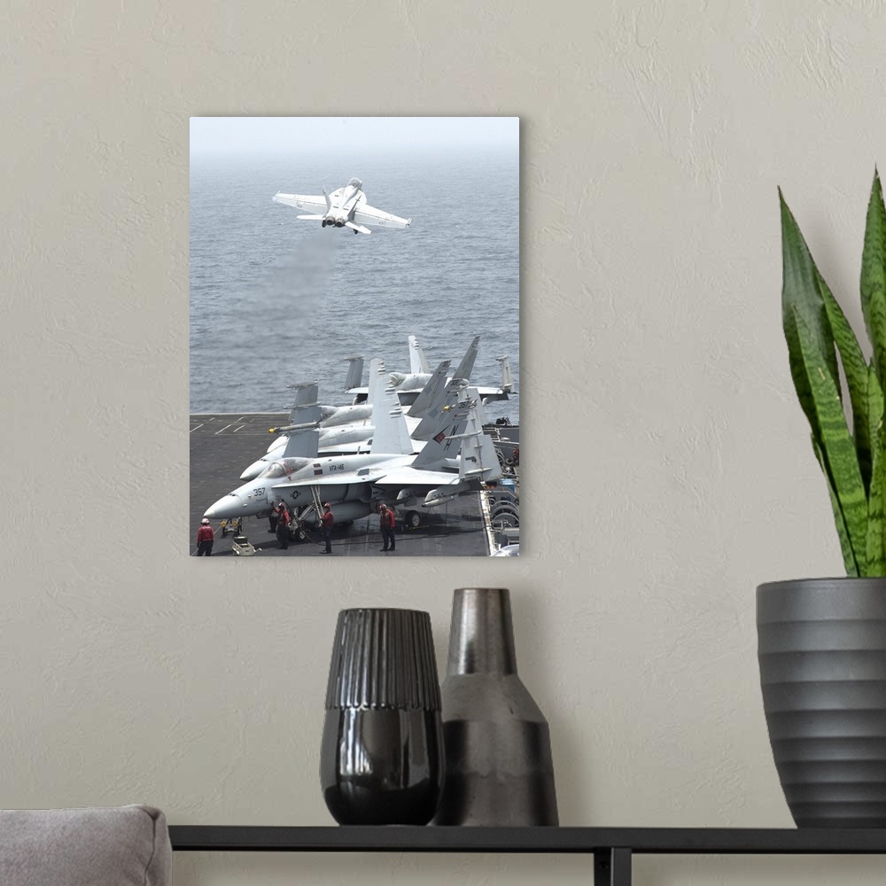 A modern room featuring Gulf of Oman, July 13, 2013 - An F/A-18F Super Hornet  launches from the flight deck of the aircr...