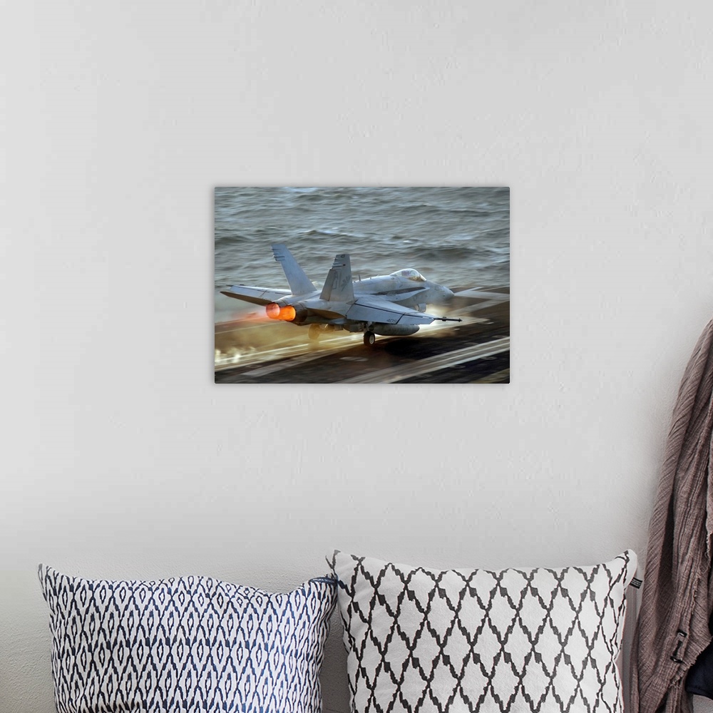 A bohemian room featuring Up-close photograph of jet taking off of an air craft carrier in the ocean.