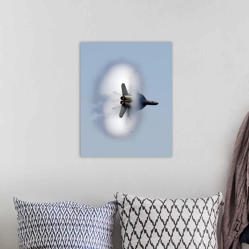 A bohemian room featuring A large piece of artwork that has a jet flying through a cloud of smoke.