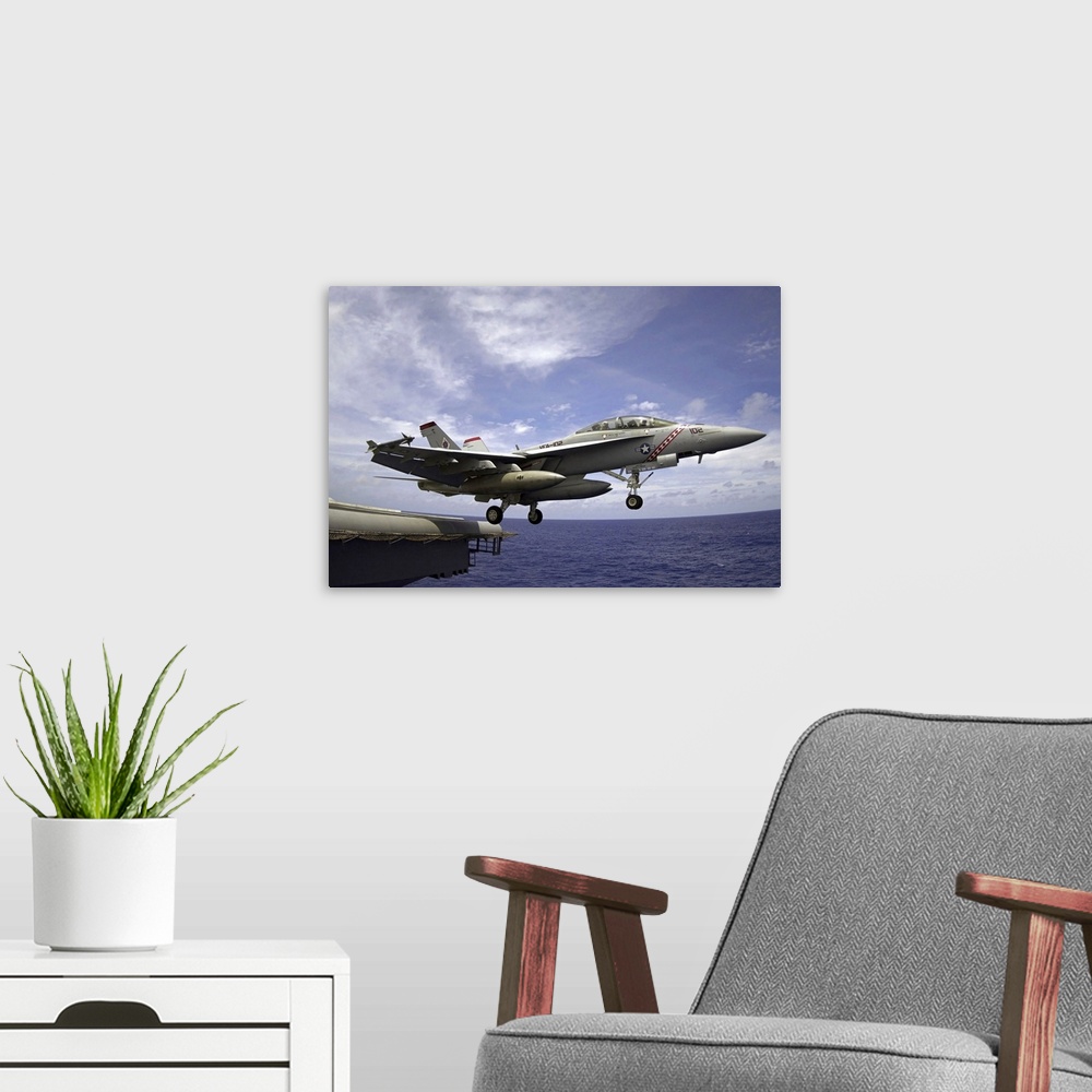 A modern room featuring An F/A18F Super Hornet launches from the flight deck of USS Kitty