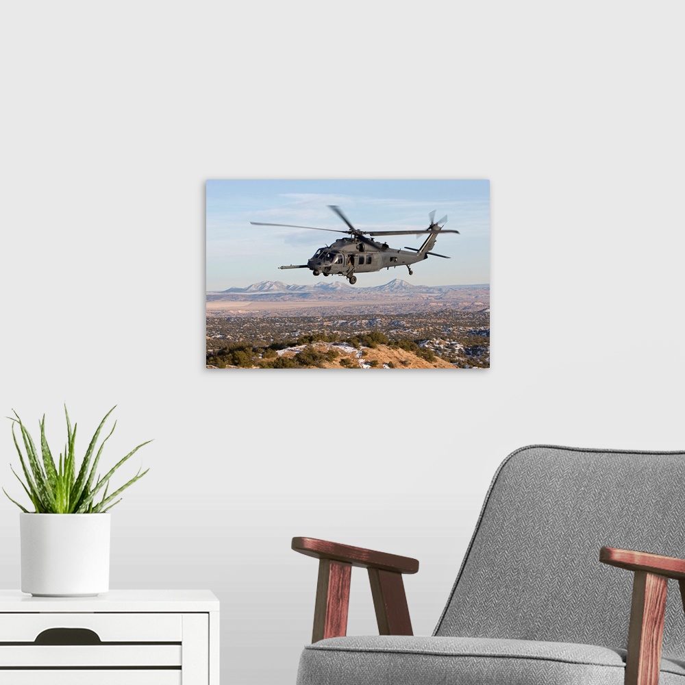 A modern room featuring An HH-60G Pave Hawk from the 512th RQS flies a low level route during a training mission out of K...