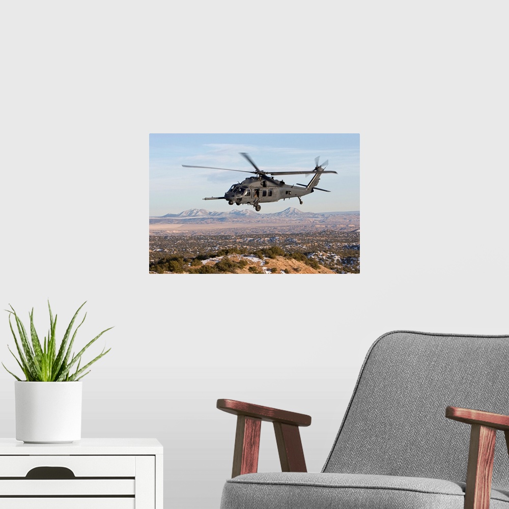 A modern room featuring An HH-60G Pave Hawk from the 512th RQS flies a low level route during a training mission out of K...