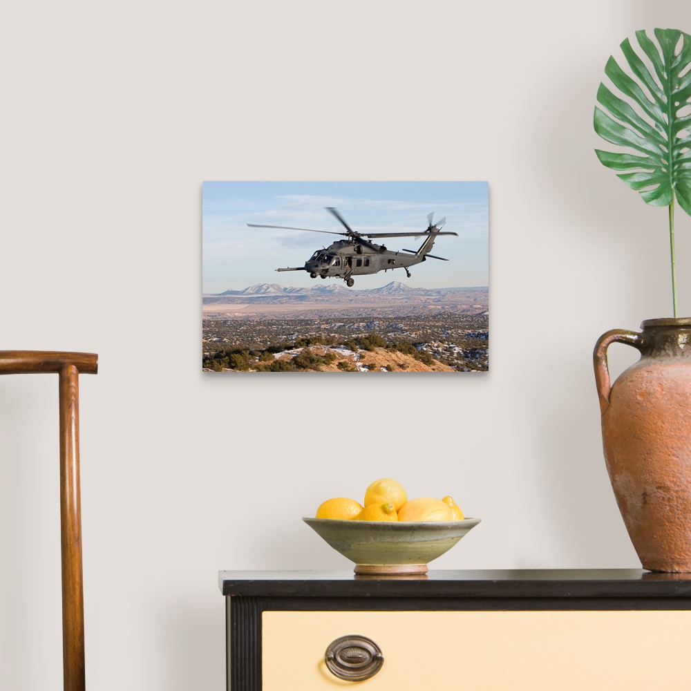 A traditional room featuring An HH-60G Pave Hawk from the 512th RQS flies a low level route during a training mission out of K...