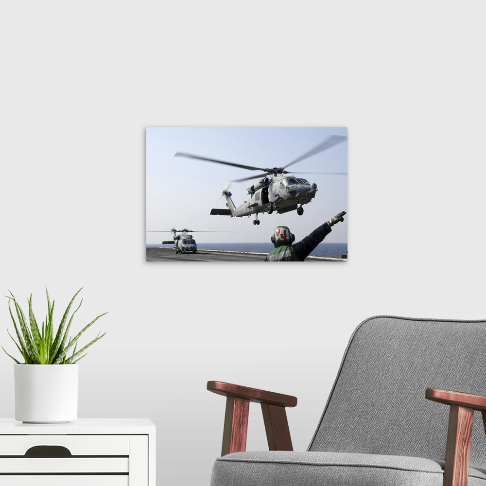 A modern room featuring Pacific Ocean, March. 13, 2011 - An HH-60H Sea Hawk helicopter launches from the aircraft carrier...