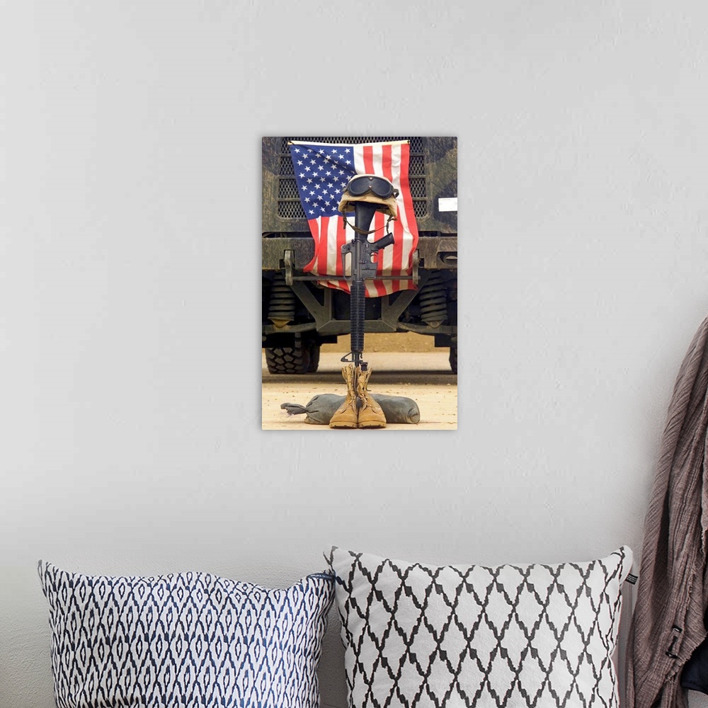 A bohemian room featuring Tall photo on canvas of a rifle sticking out of two boots with a helmet on top in front of an Ame...