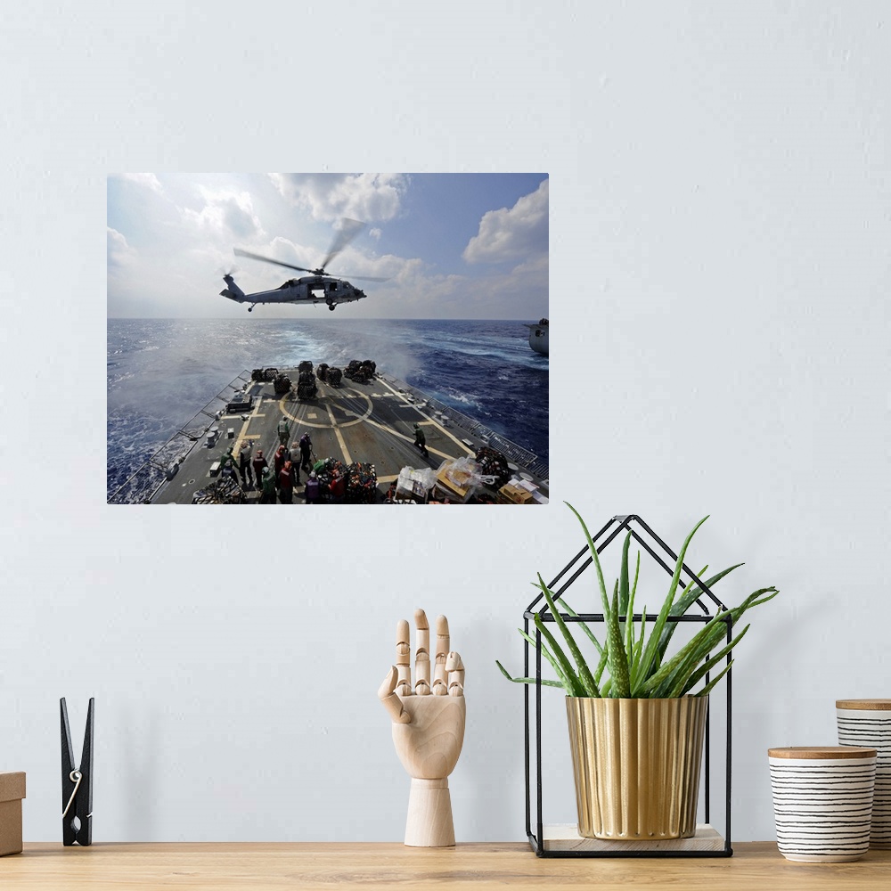A bohemian room featuring South China Sea, October 25, 2011 - An MH-60R Sea Hawk helicopter transfers supplies to the fligh...