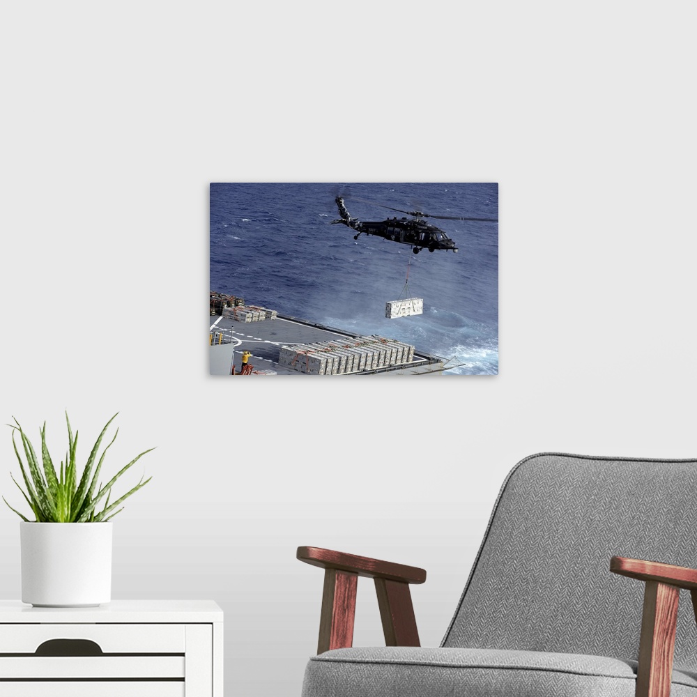 A modern room featuring Atlantic Ocean, January 15, 2013 - An MH-60S Sea Hawk helicopter picks up ammunition from the Mil...