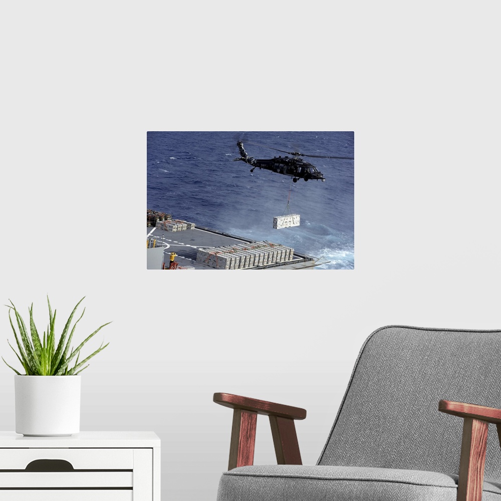 A modern room featuring Atlantic Ocean, January 15, 2013 - An MH-60S Sea Hawk helicopter picks up ammunition from the Mil...