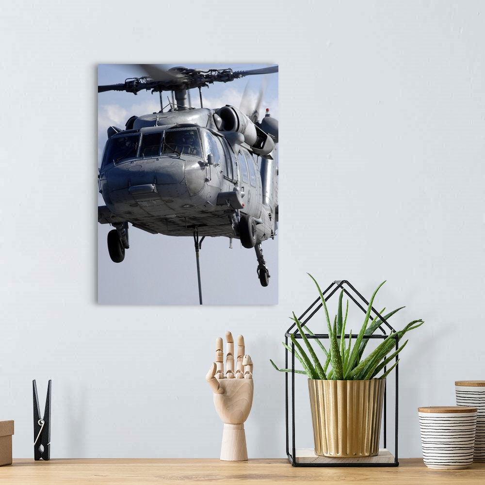 A bohemian room featuring An MH-60S Seahawk delivers a pallet of MK 83/BLU-110 general-purpose bombs.