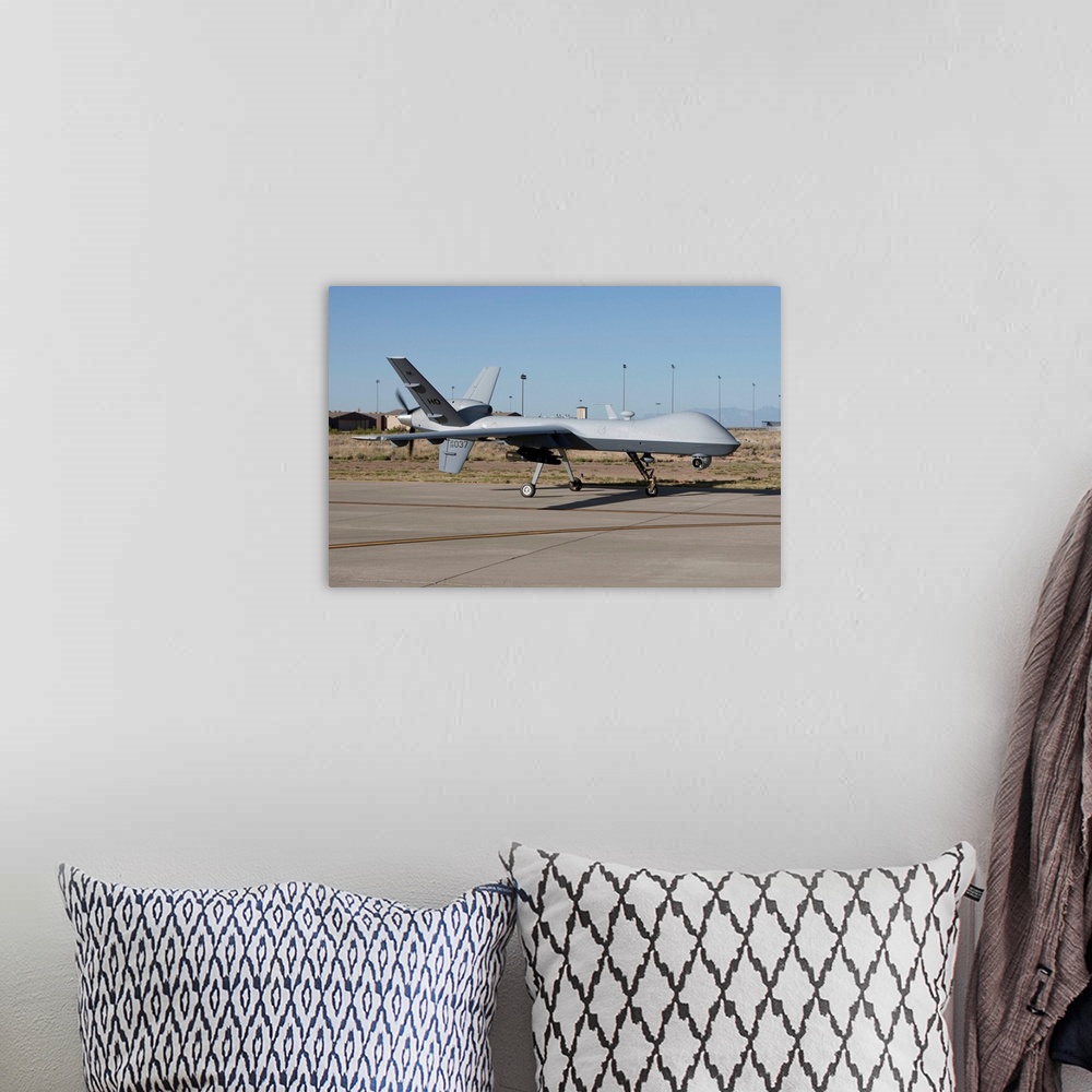 A bohemian room featuring An MQ-9 Reaper taxi's to the runway at Holloman Air Force Base, New Mexico.