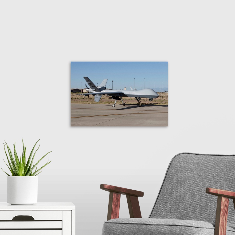 A modern room featuring An MQ-9 Reaper taxi's to the runway at Holloman Air Force Base, New Mexico.