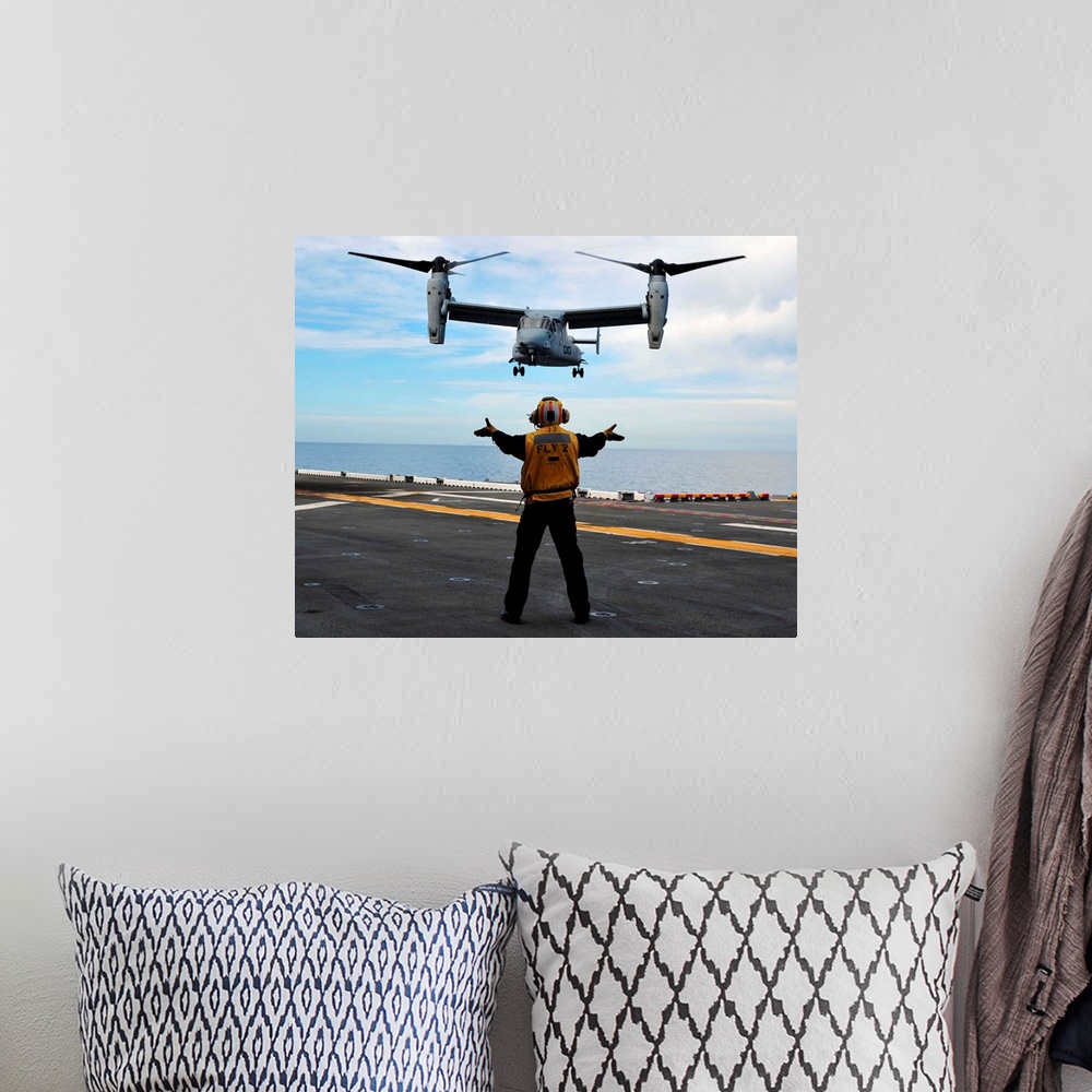 A bohemian room featuring March 1, 2011 - An MV-22 Osprey tiltrotor aircraft approaches the flight deck of the amphibious a...