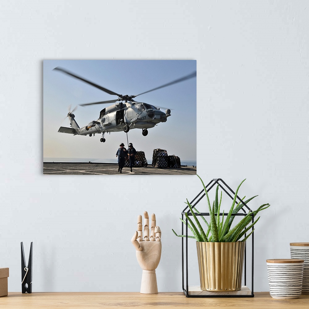 A bohemian room featuring An SH-60F Sea Hawk helicopter picks up supplies from USS Gunston Hall.