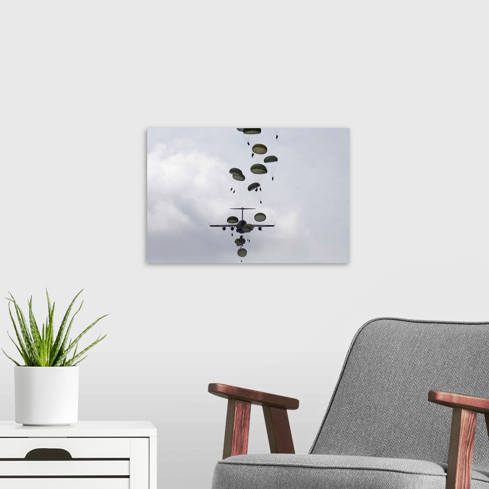 A modern room featuring Wall art of soldiers parachuting from planes.