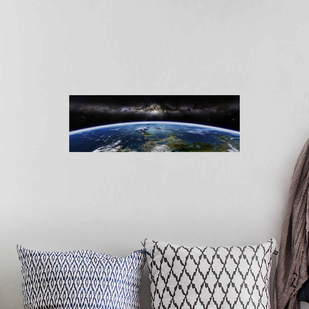 A bohemian room featuring Artist's concept of an extraterrestrial planet with a galaxy on the horizon.
