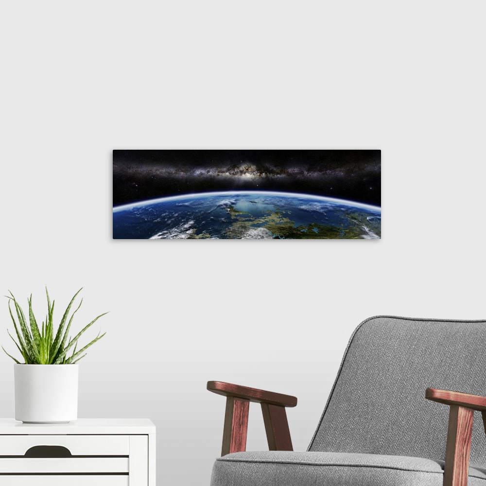 A modern room featuring Artist's concept of an extraterrestrial planet with a galaxy on the horizon.